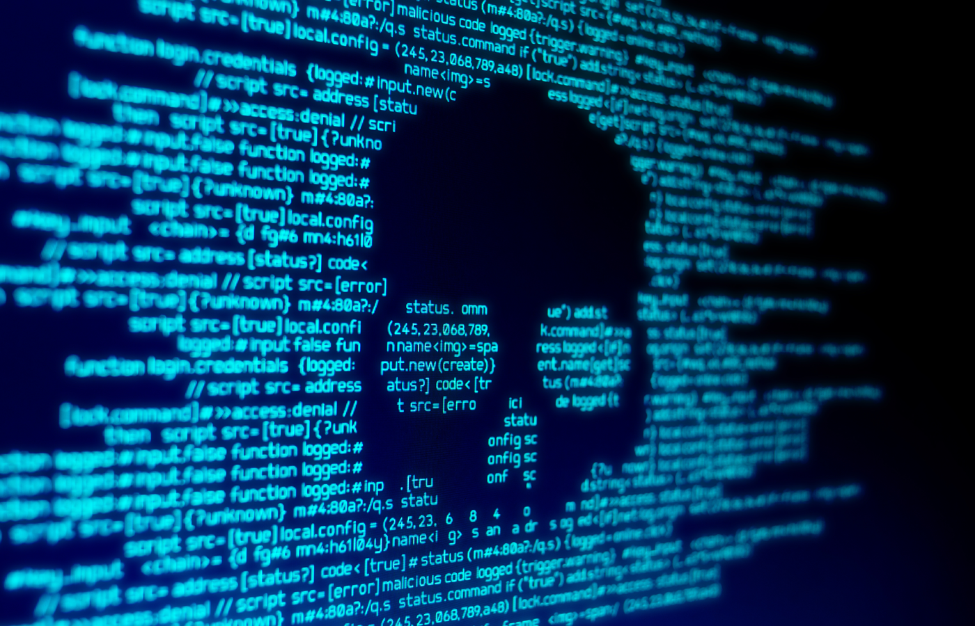 Computer code on a screen with a skull representing a computer virus.