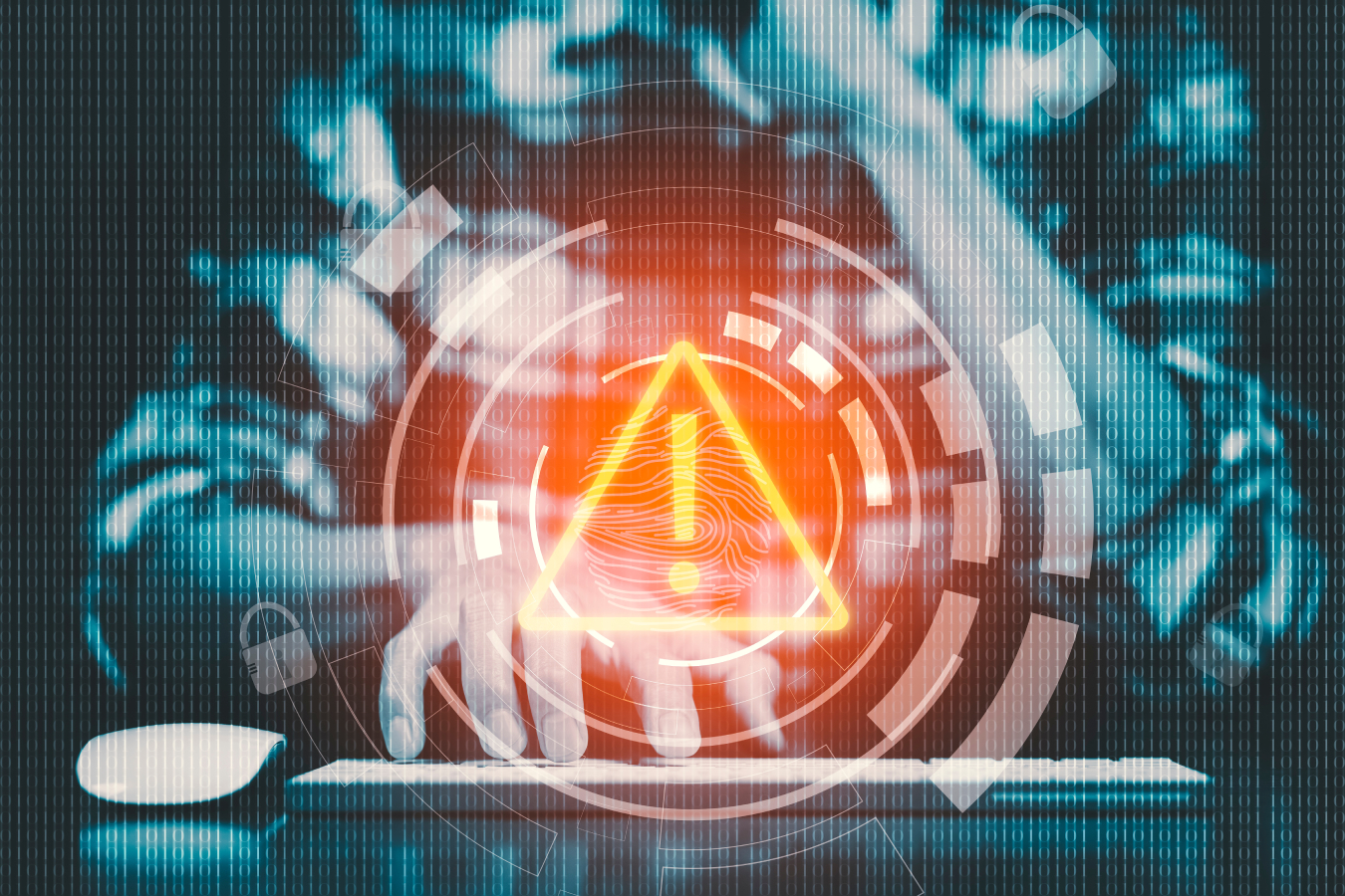 A hacker working on computer with warning graphic on the center.