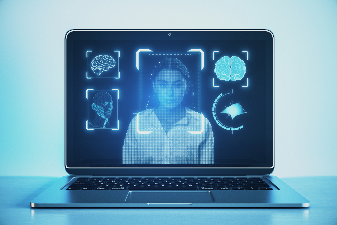 Laptop on desk with face recognition hologram on light backdrop.