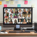 A computer monitor featuring a conference call with a remote team for work.