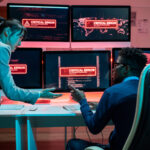 Two young intercultural programmers trying to solve problem with access to data.
