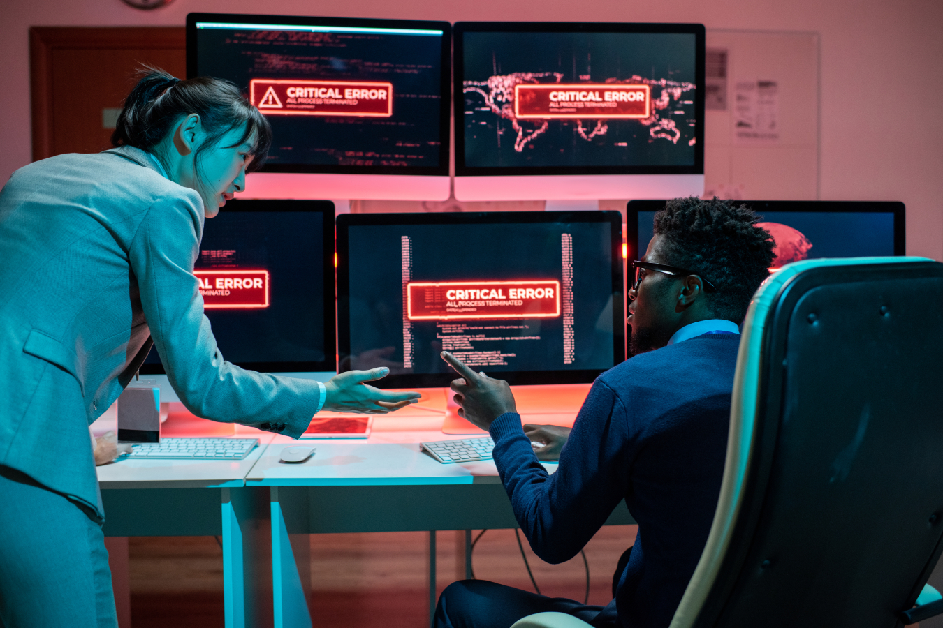 Two young intercultural programmers trying to solve problem with access to data.