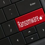 Computer Keyboard with red RANSOMWARE and lit bomb.