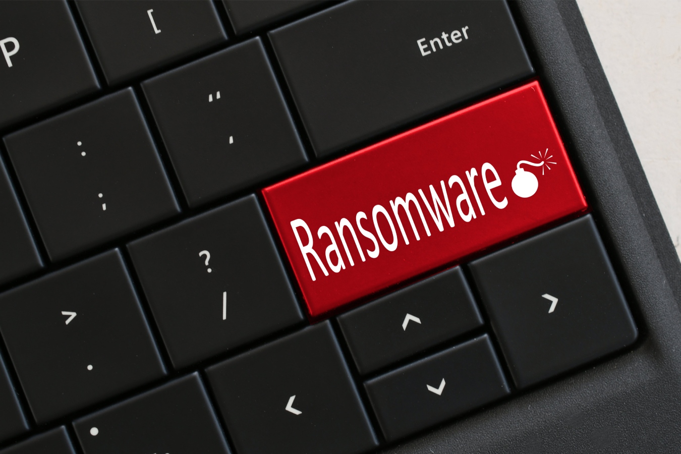Computer Keyboard with red RANSOMWARE and lit bomb.